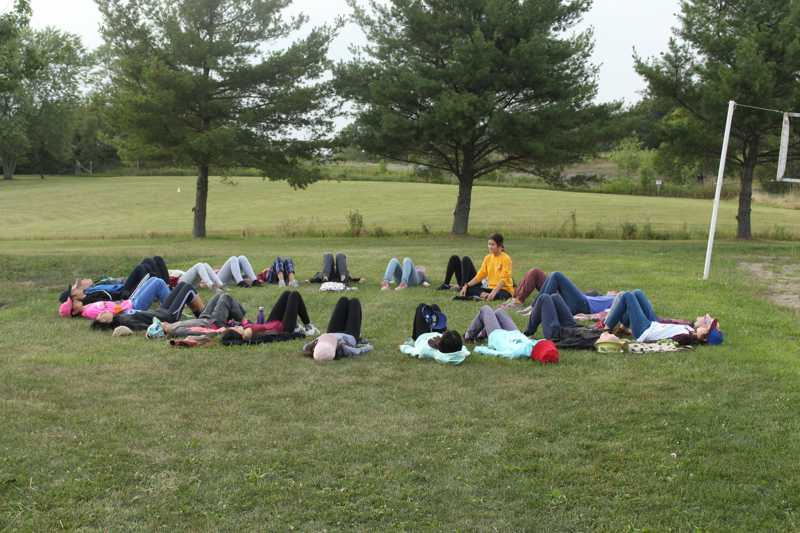 Campers in a circle on the grass